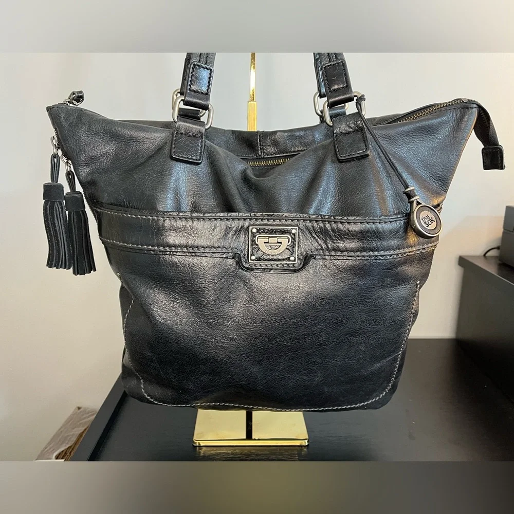 The Sak Expandable Black Leather Suede Shoulder Tote Bag with Suede Tassels